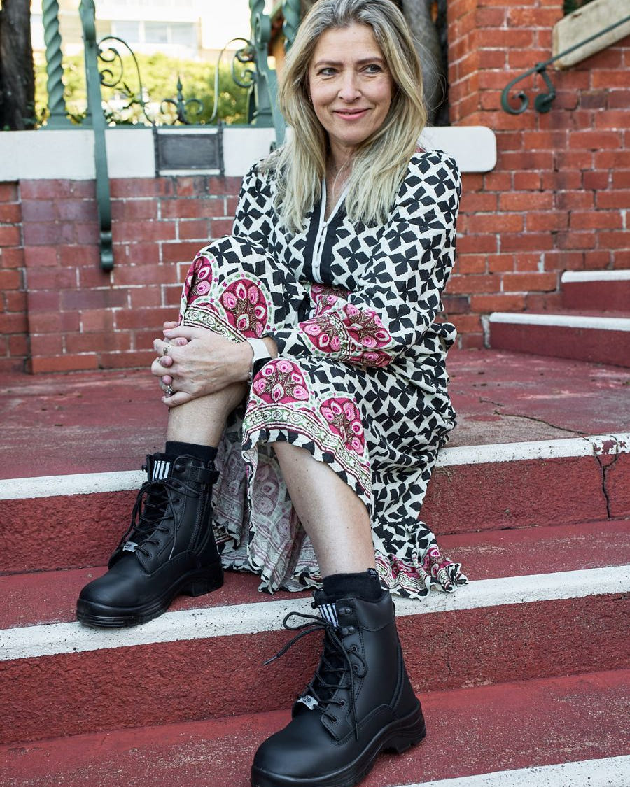 Woman sat down wearing black boots
