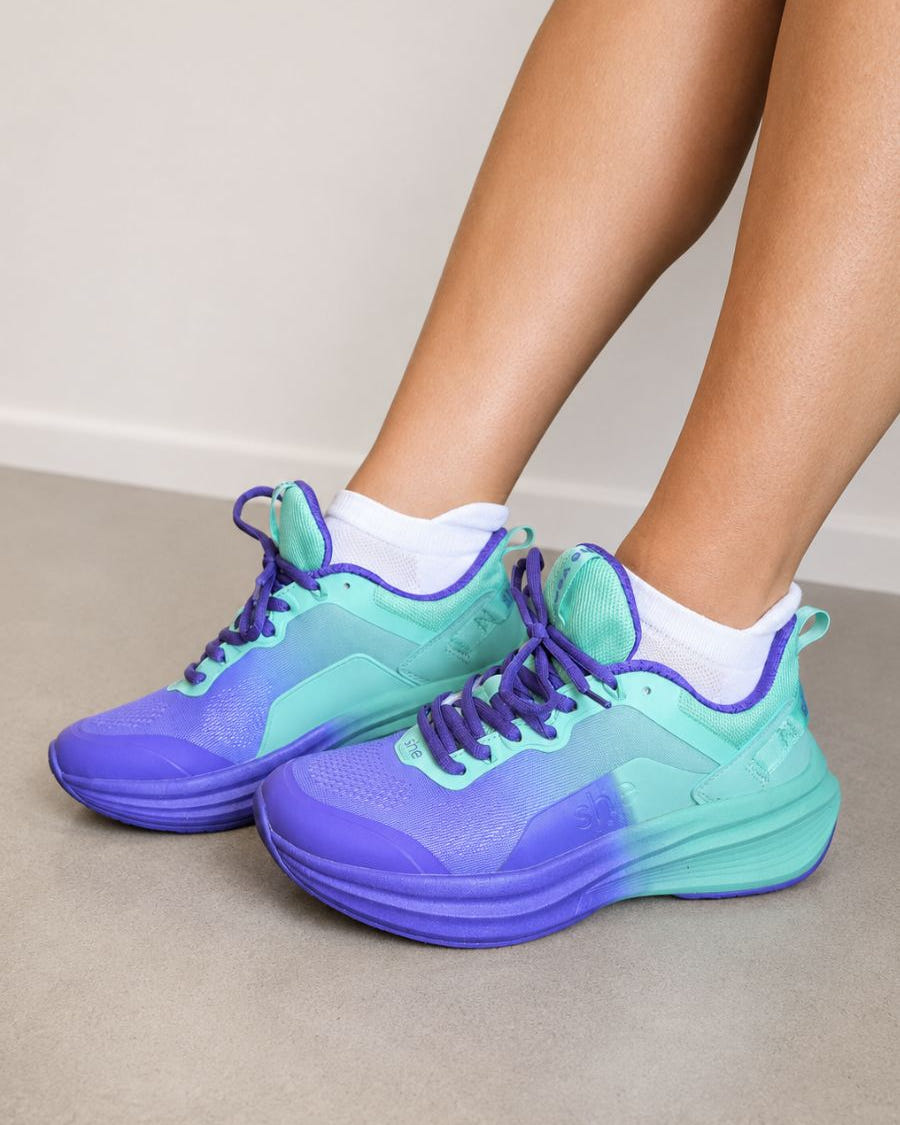a pair of purple walking shoes being worn with white ankle socks