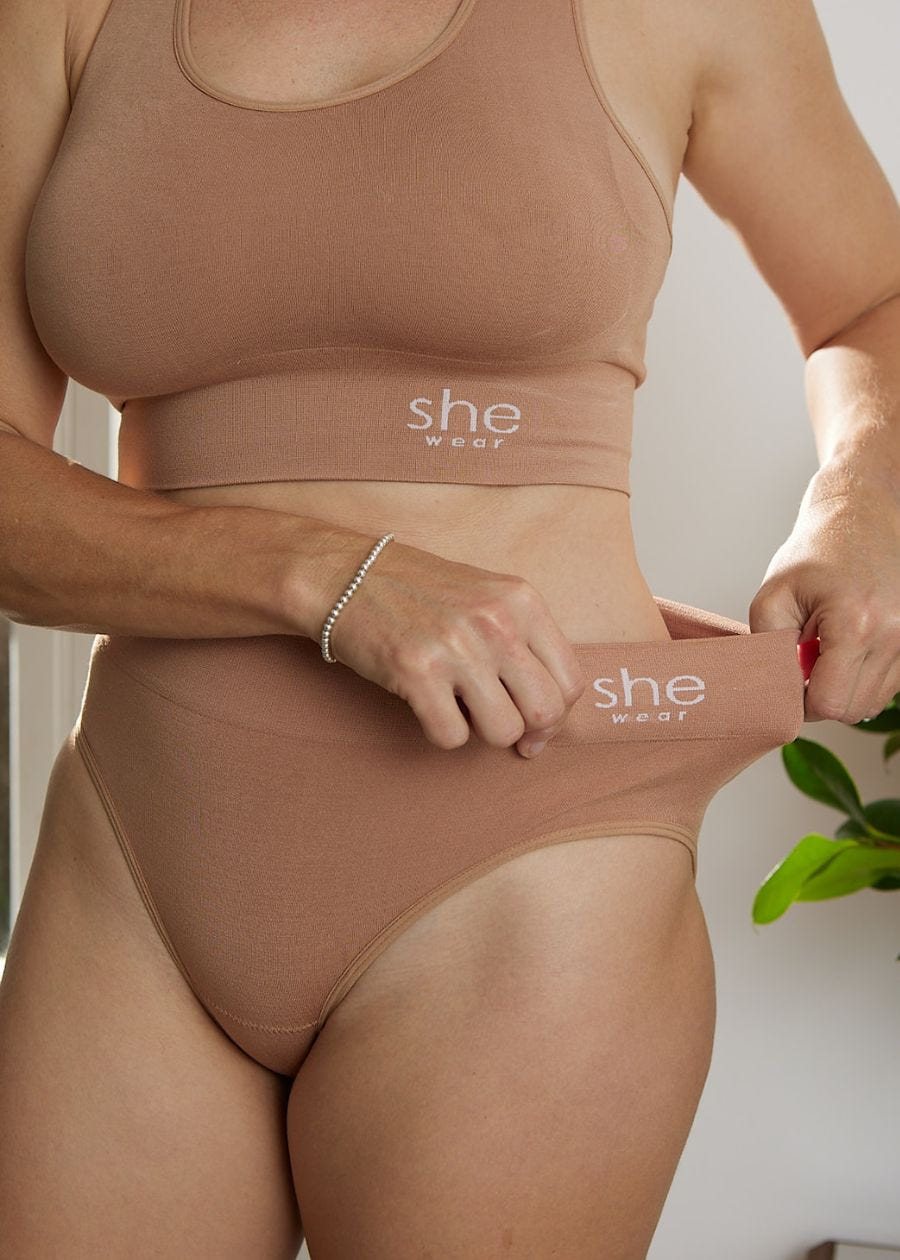 Woman demonstrating stretch on waistband for organic bamboo briefs
