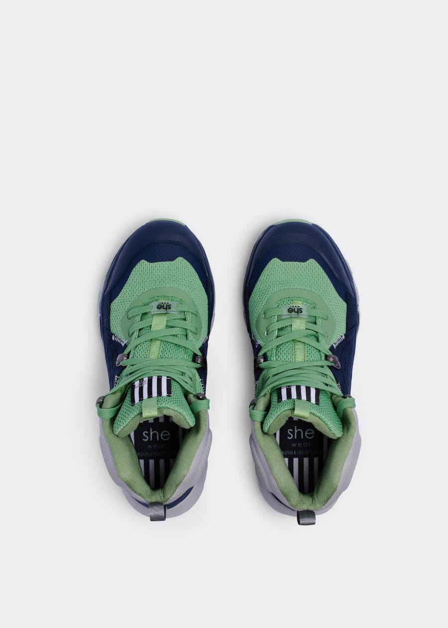 Birds eye view of padded collar and heel on green and navy hiking boots with green laces.