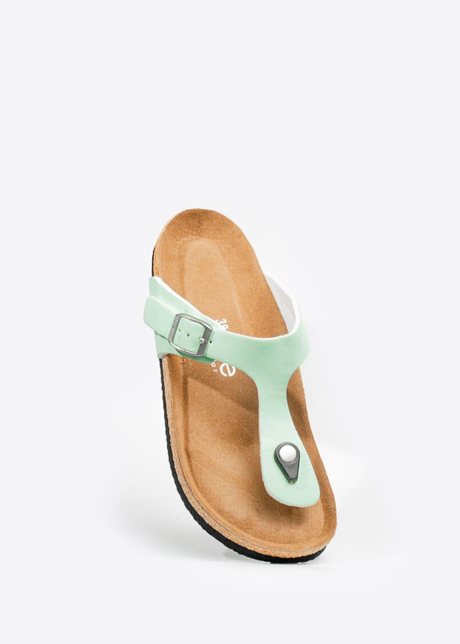 Front, tilted view of women's thong style, cork slip-on shoe in the colour honeydew