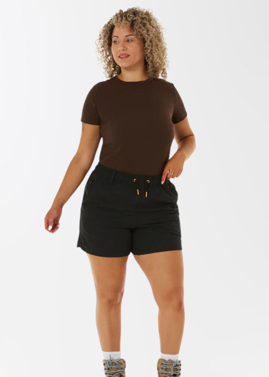 woman in brown shirt and black work boots with drawstring waist