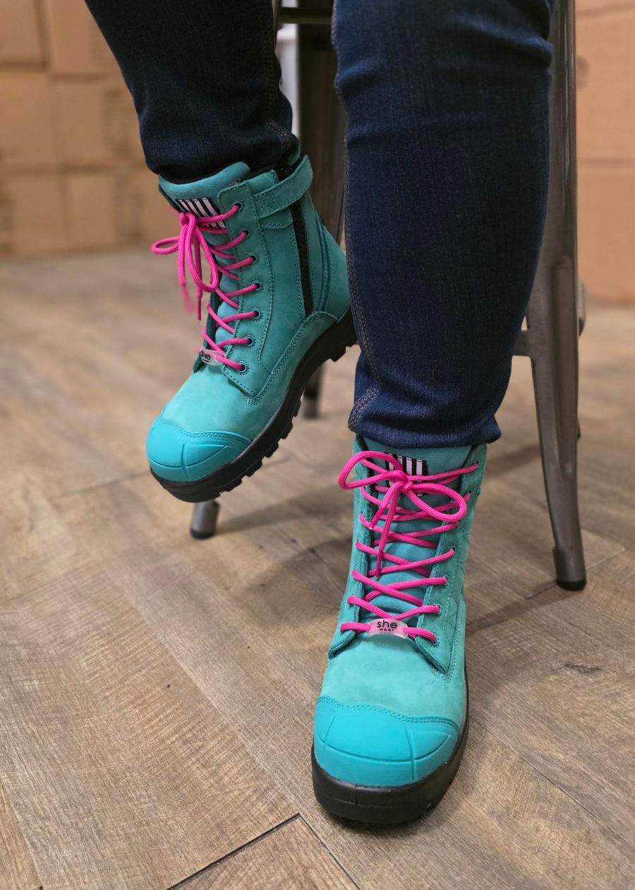 Woman sat on foot stool wearing aqua safety boots