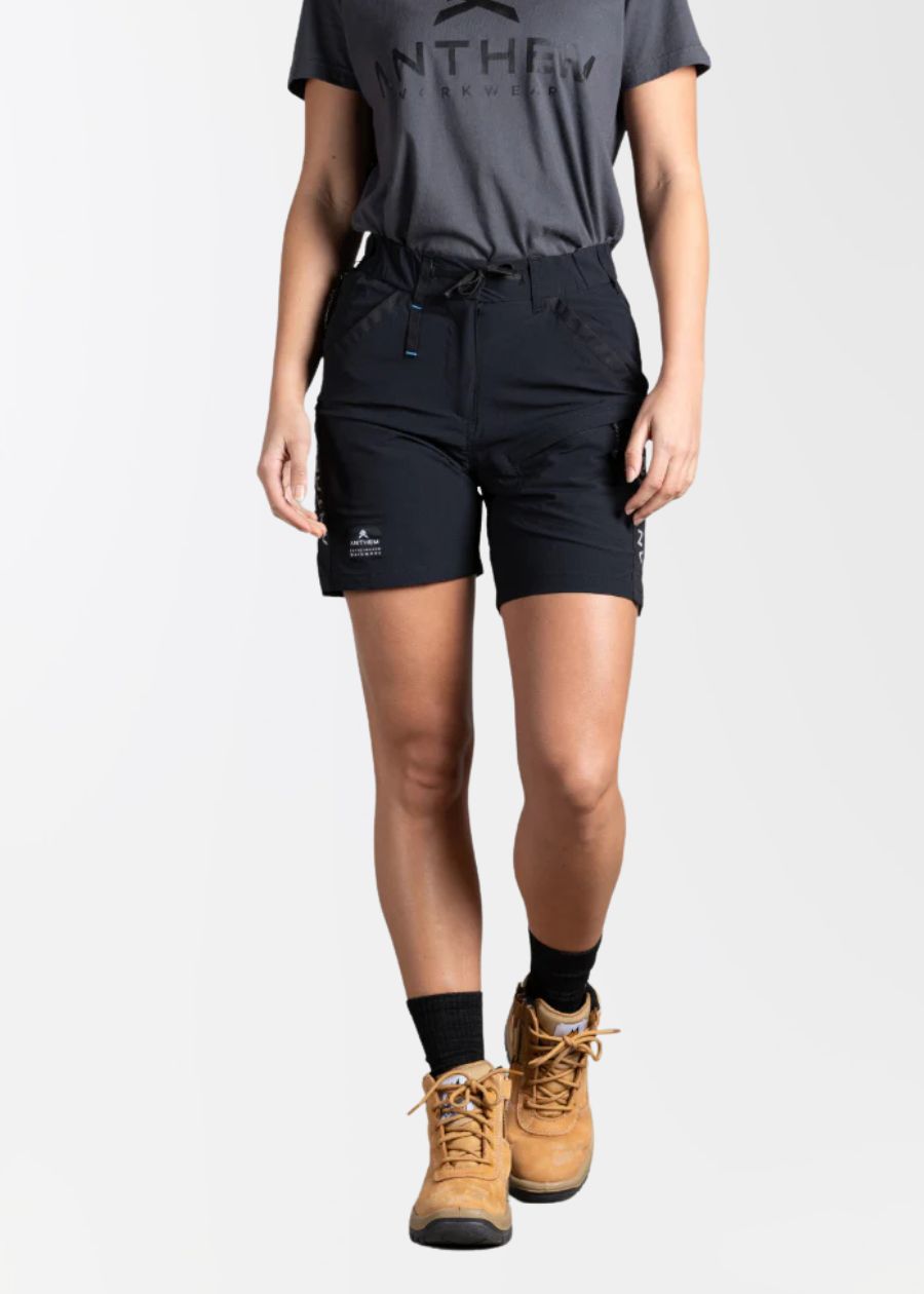 Front view of woman wearing black light weight work shorts, with drawstring waistband. 