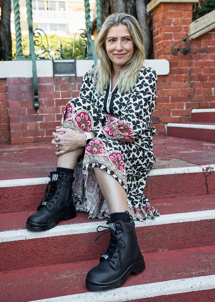 Woman sat down wearing black boots