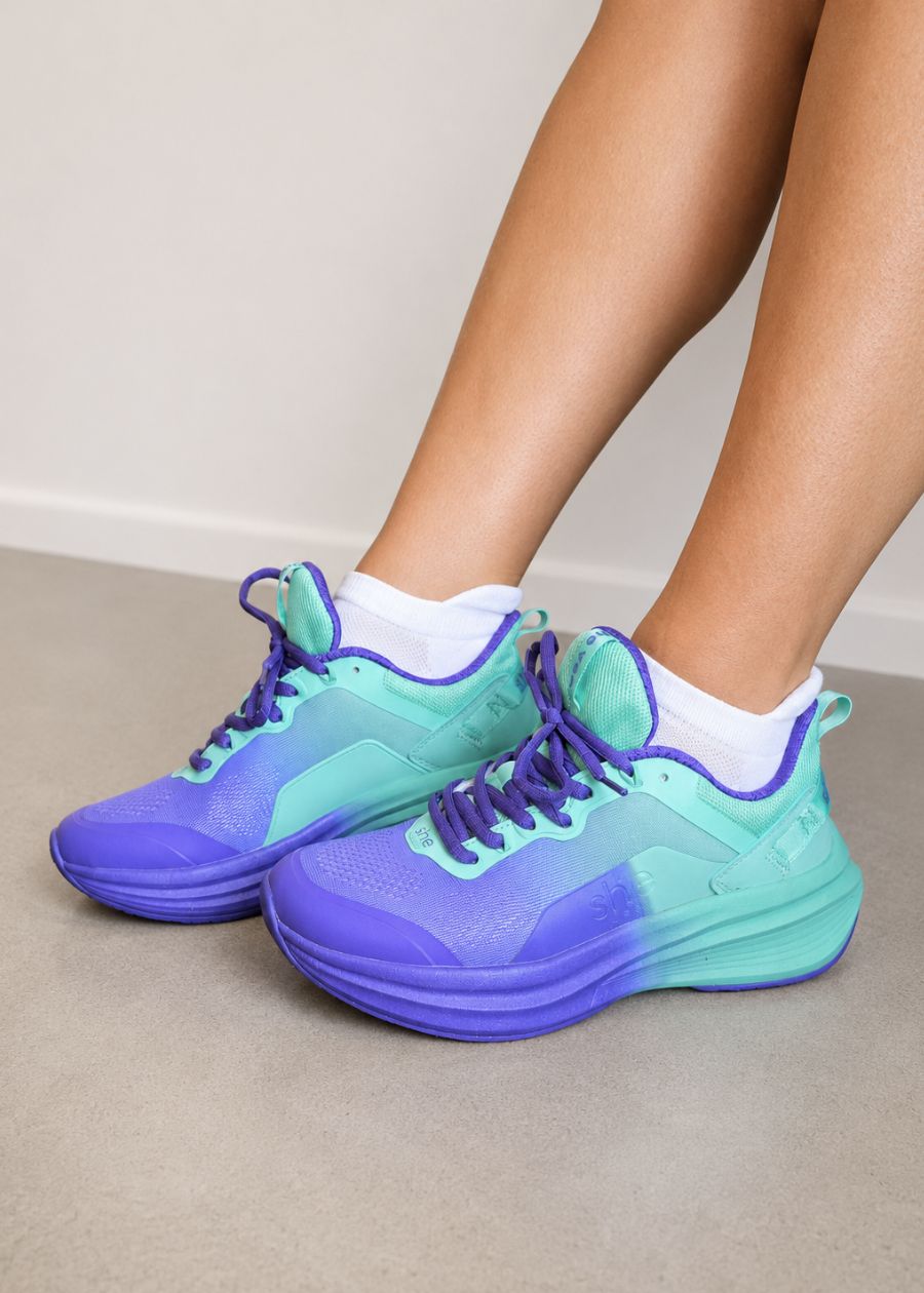 a pair of purple walking shoes being worn with white ankle socks