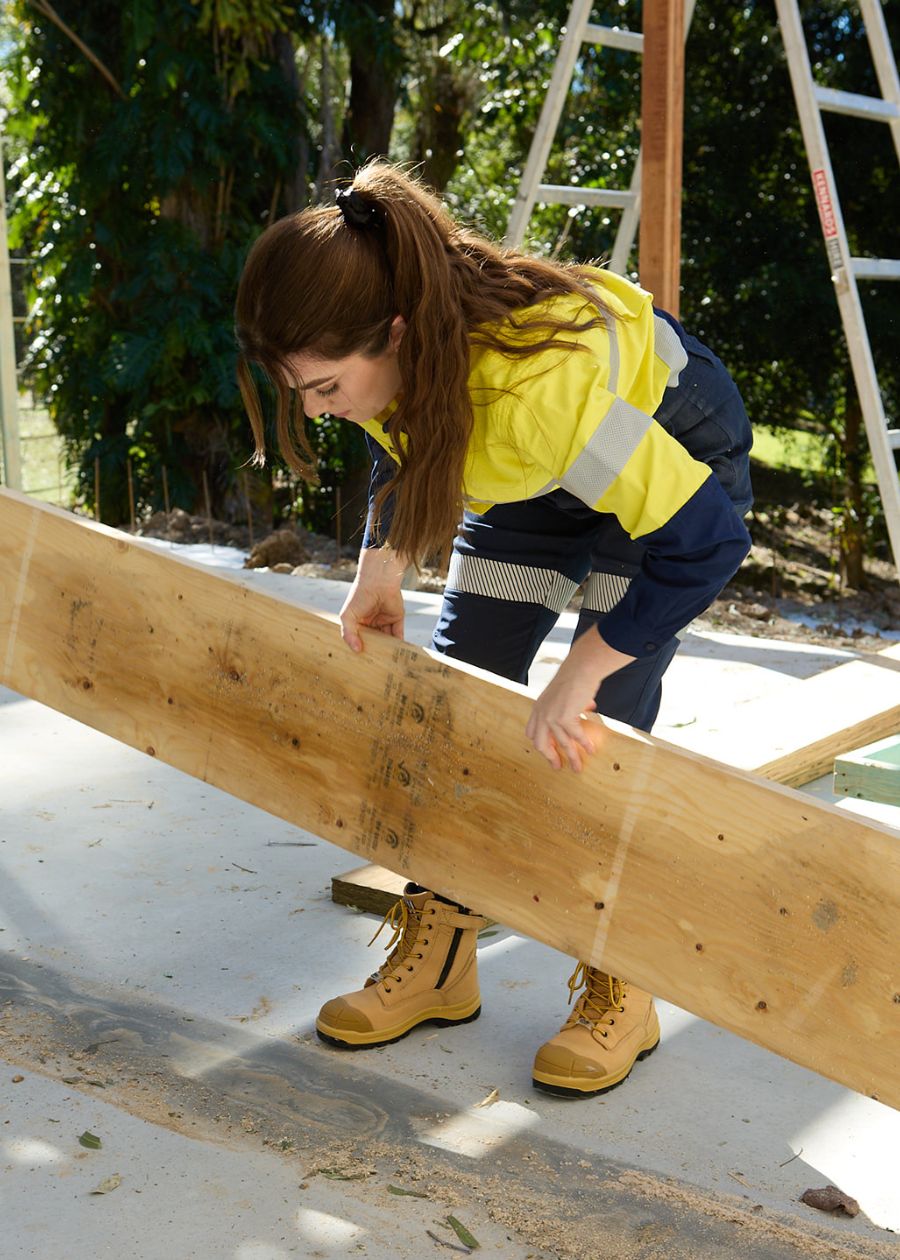 Woman doing construction work in wheat coloured safety boots. 