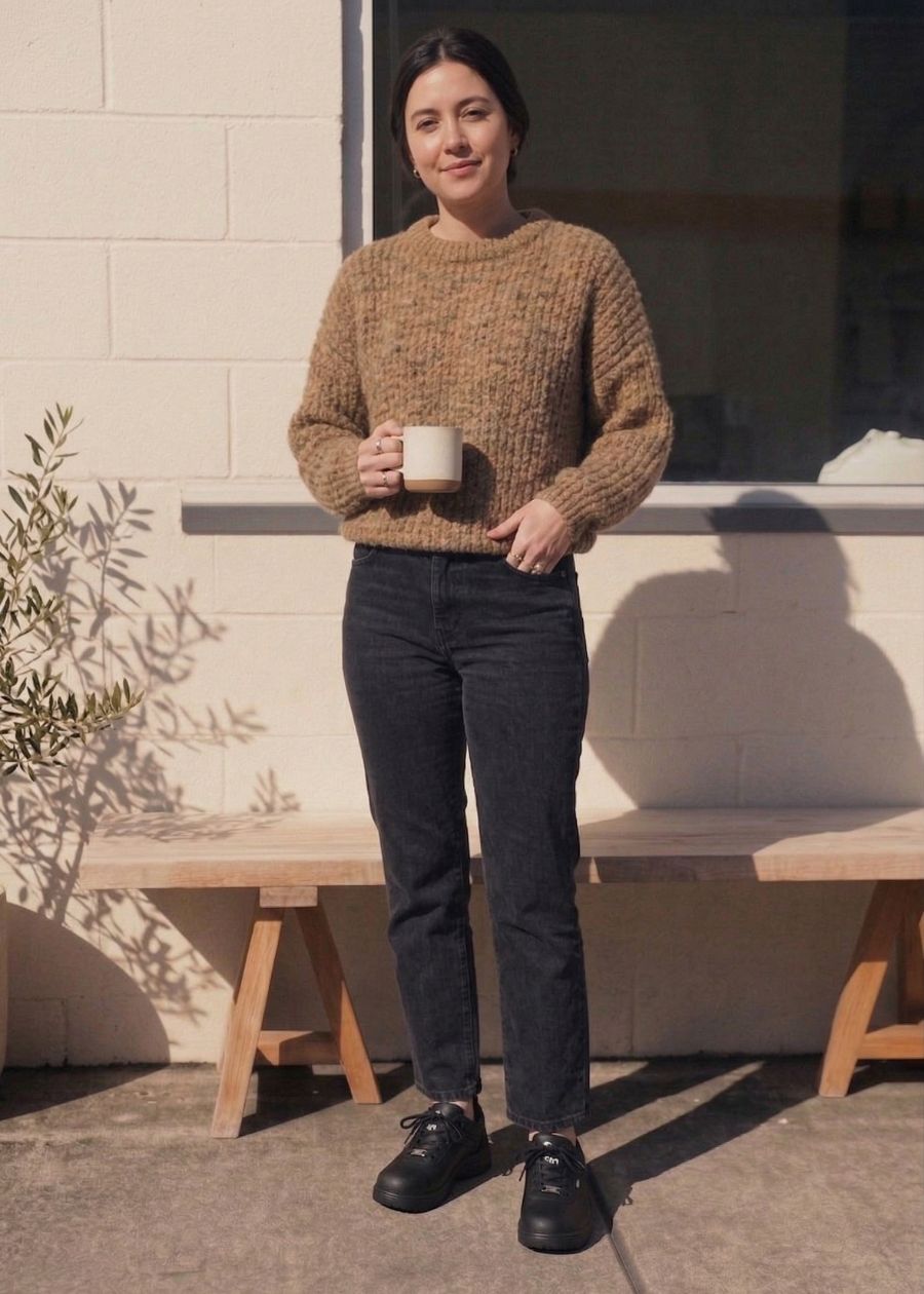 Woman stood up outside coffee shop wearing black wide fit work shoe