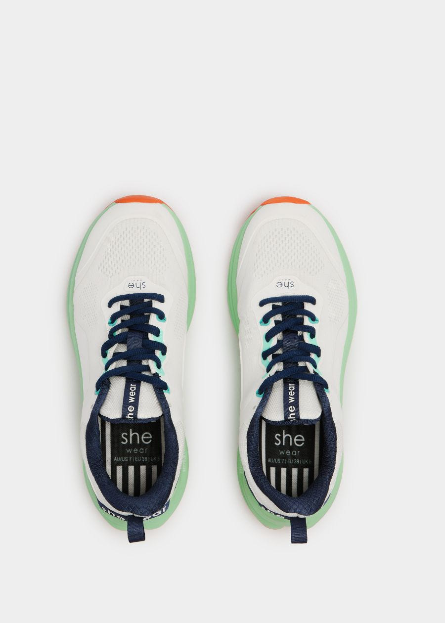 Birds eye view of white walking shoe with navy laces and navy inner lining 