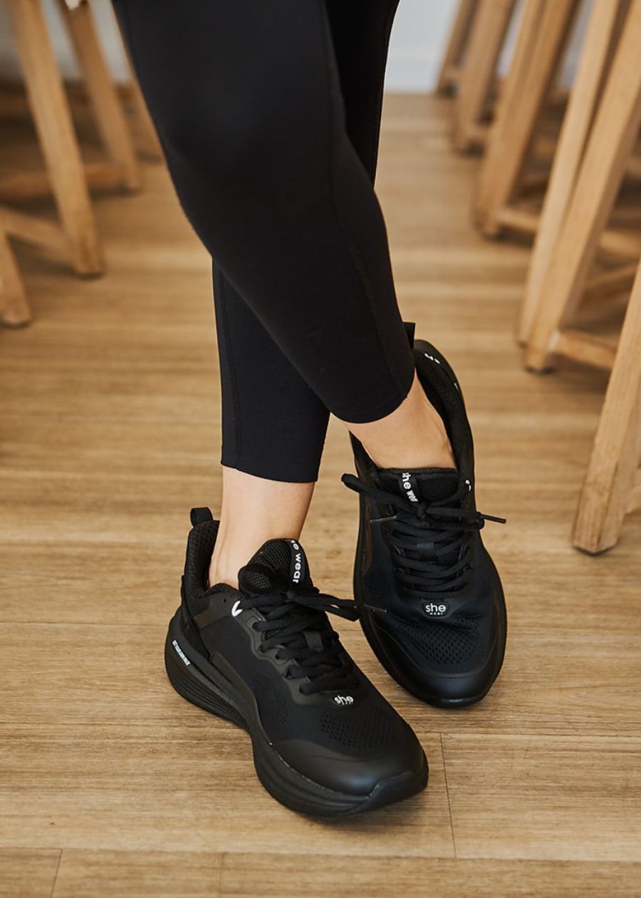 woman wearing black pace shoe close up