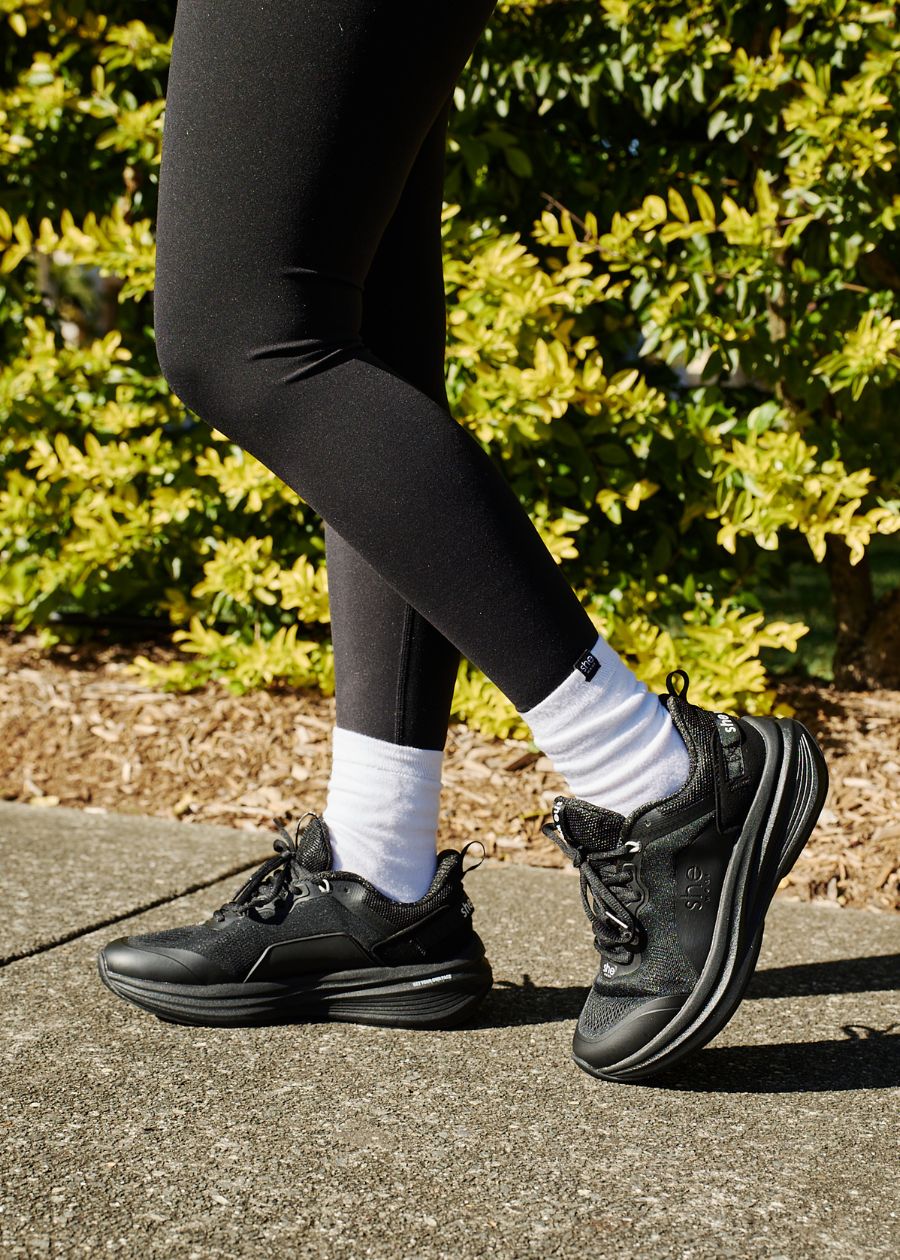 Woman wearing black Pace sneaker