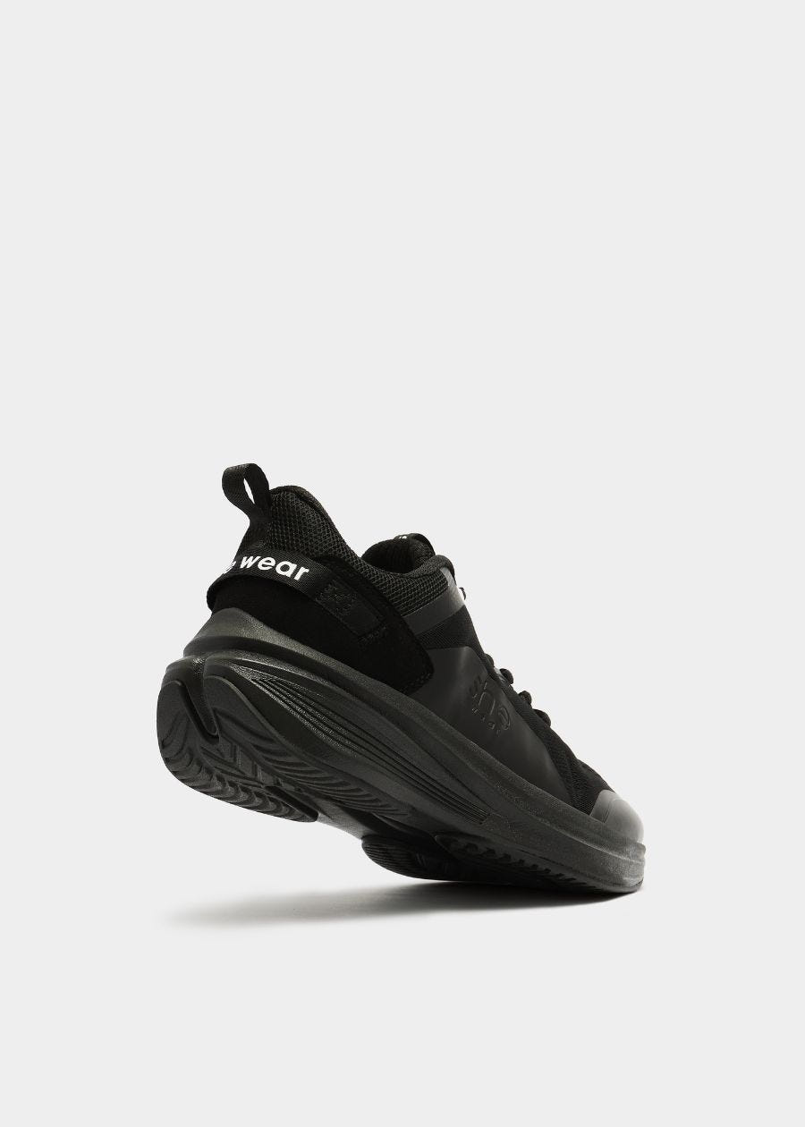 Back angled view of she wear Pace women's walking shoe in black, showing sole grip and supportive design