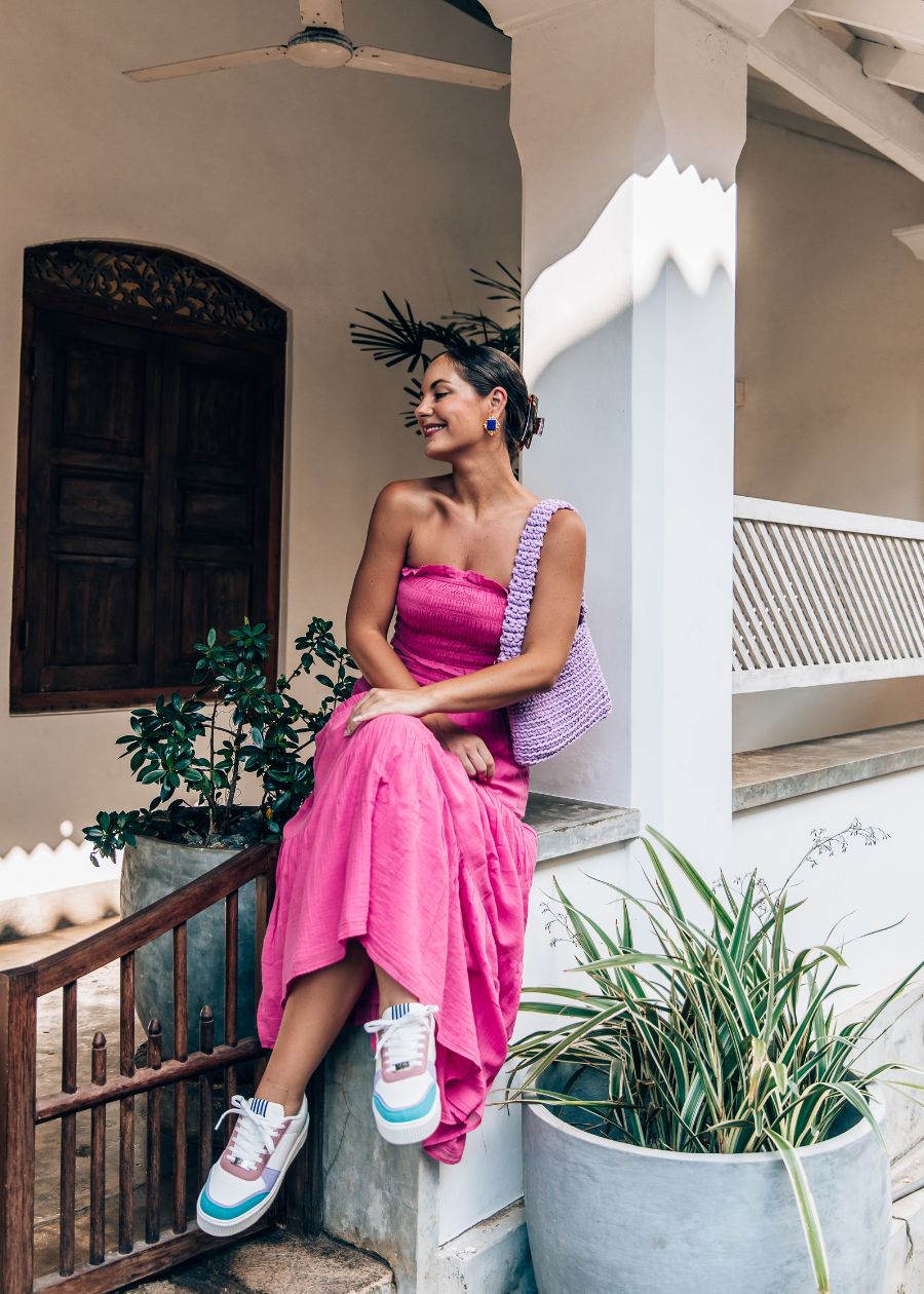 lady in pink wearing she wear rise sneakers
