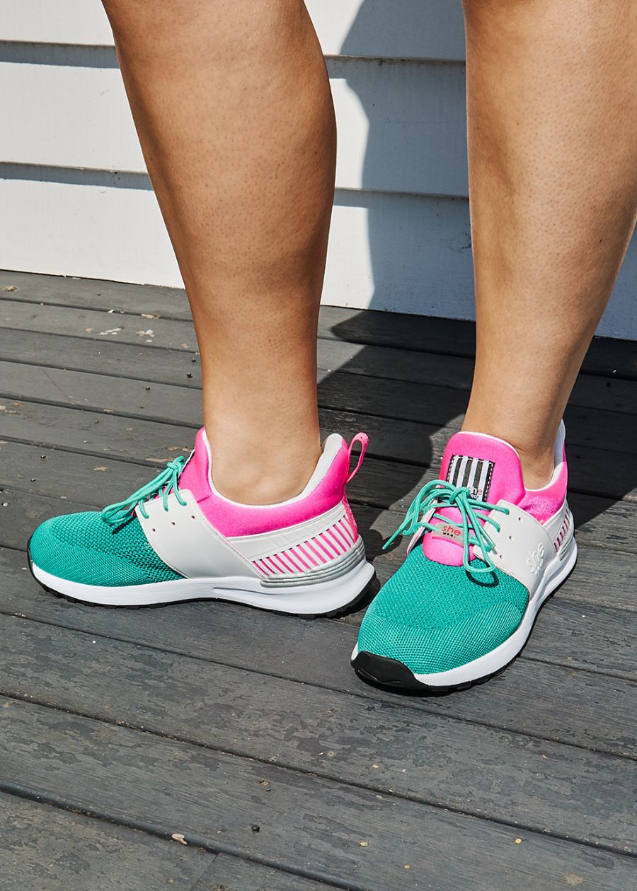 Close up, women's active sneaker in pink, white, and mint green with green laces. 
