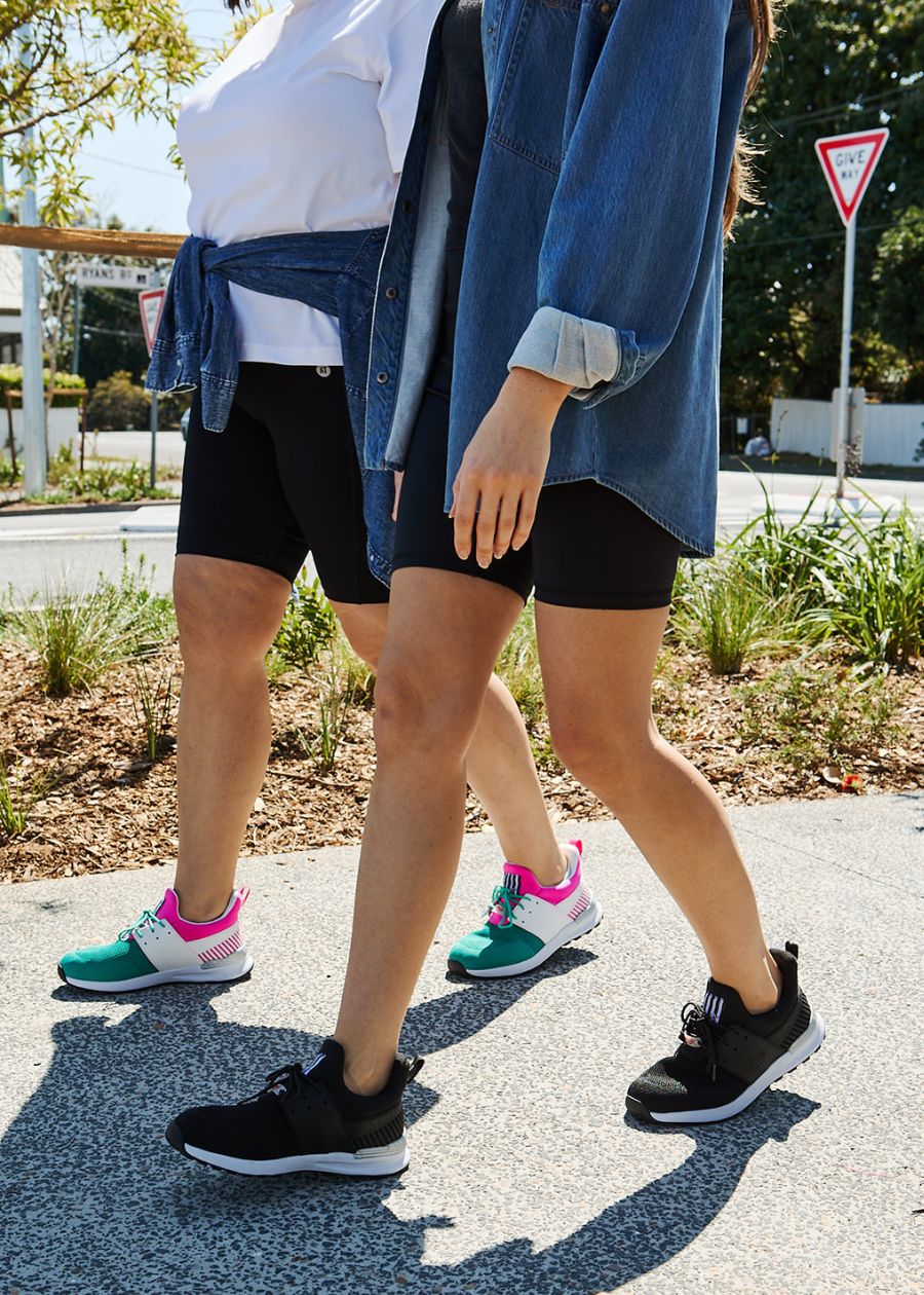 Women walking along side walk in Steps active sneaker. 