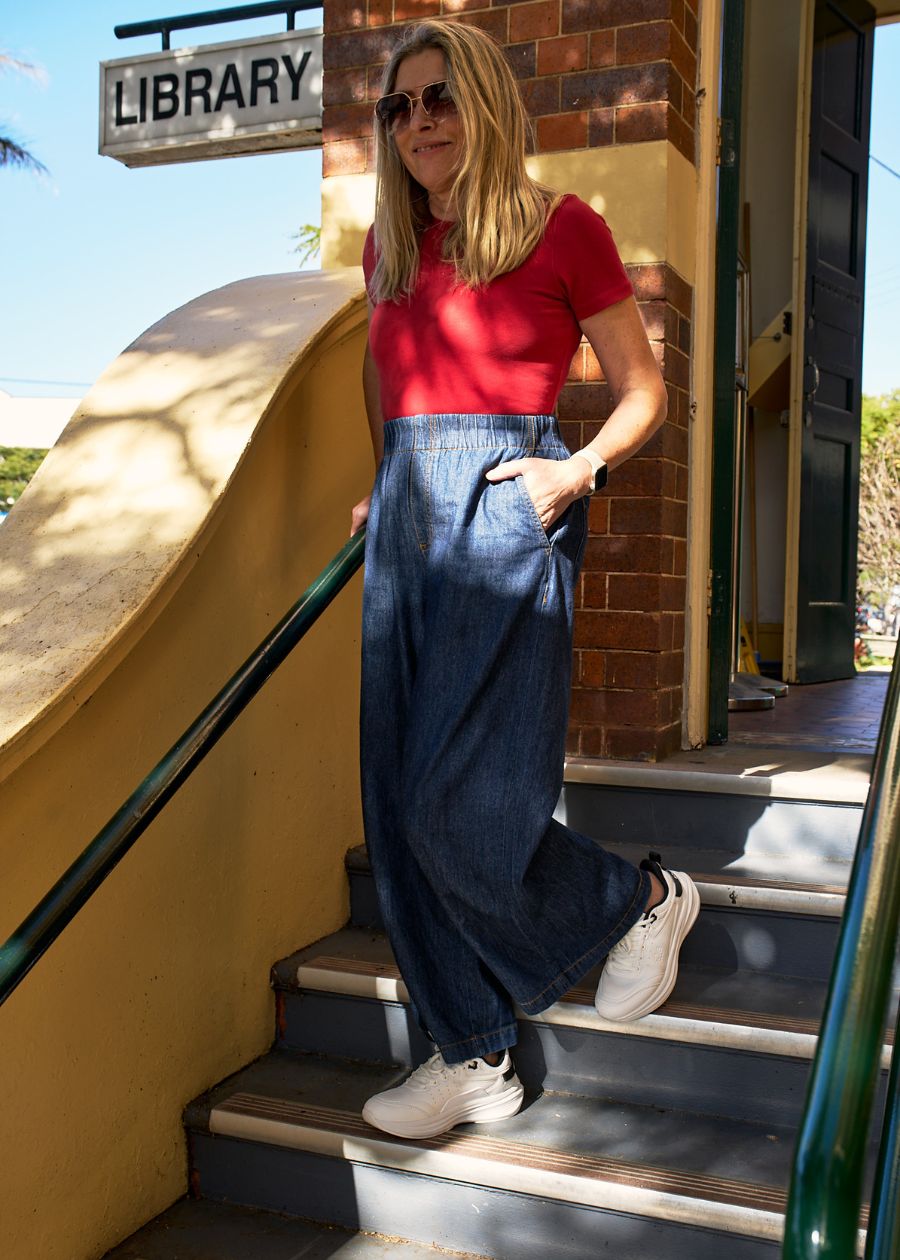 Lady stood in steps wearing white walking shoe