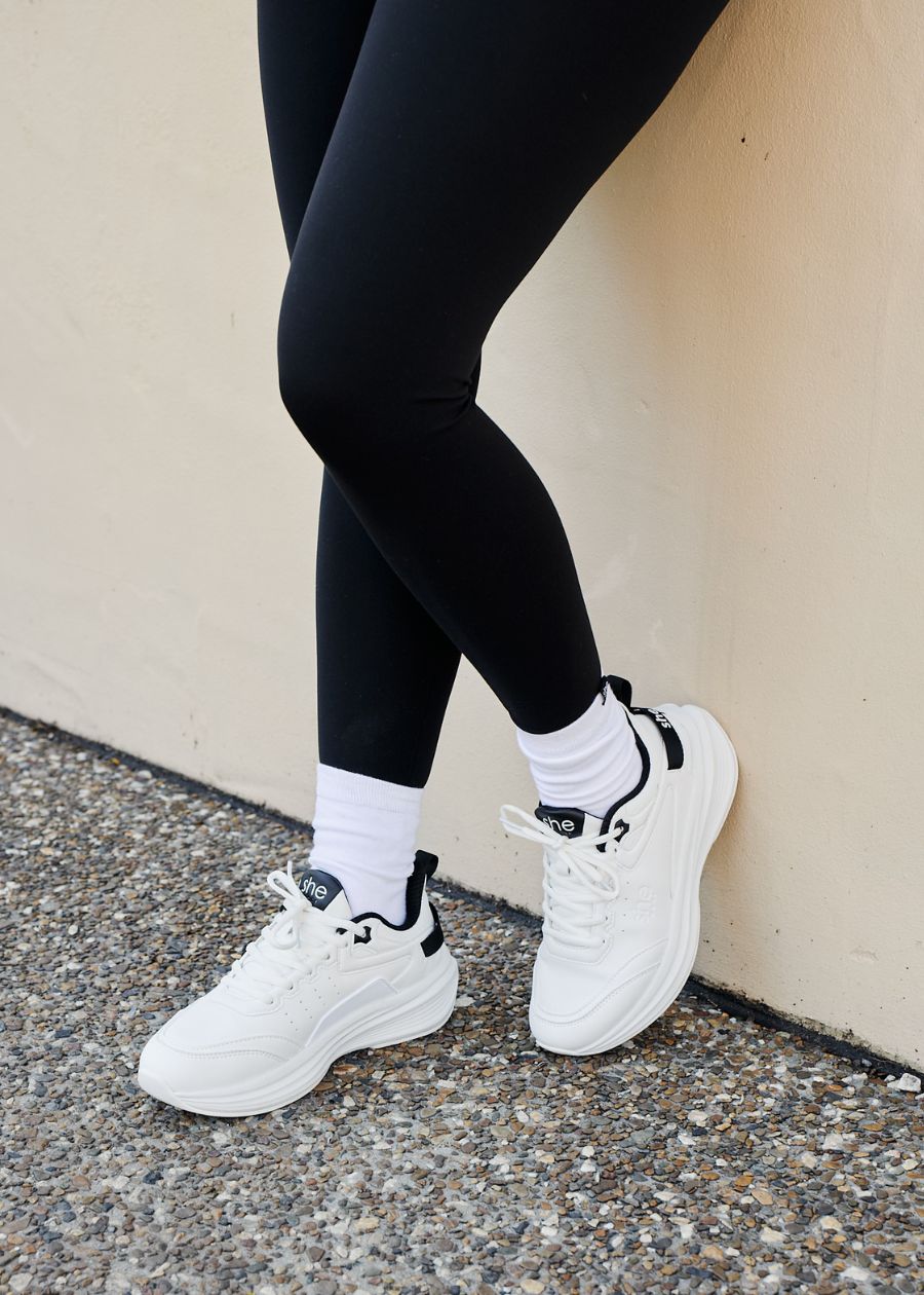 woman wearing white walking shoe