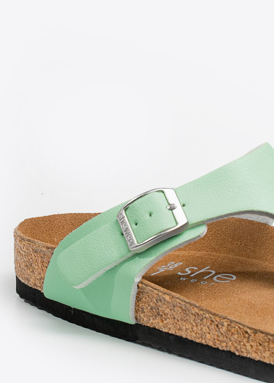 Silver buckle detail on Wander women's slides in honeydew